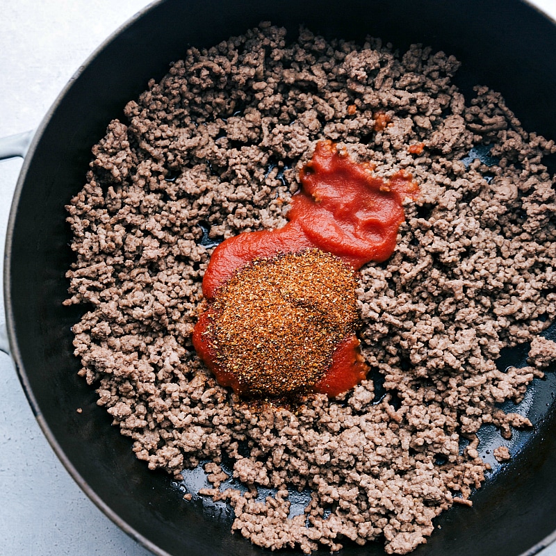 Process shot-- Image of the seasoning mix and tomato sauce being added to the beef.