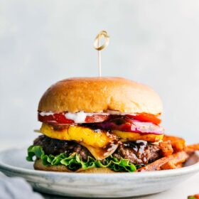 Ready to eat delicious and flavor-packed teriyaki burger, complete with all its toppings between a buttery bun and fries on the side.