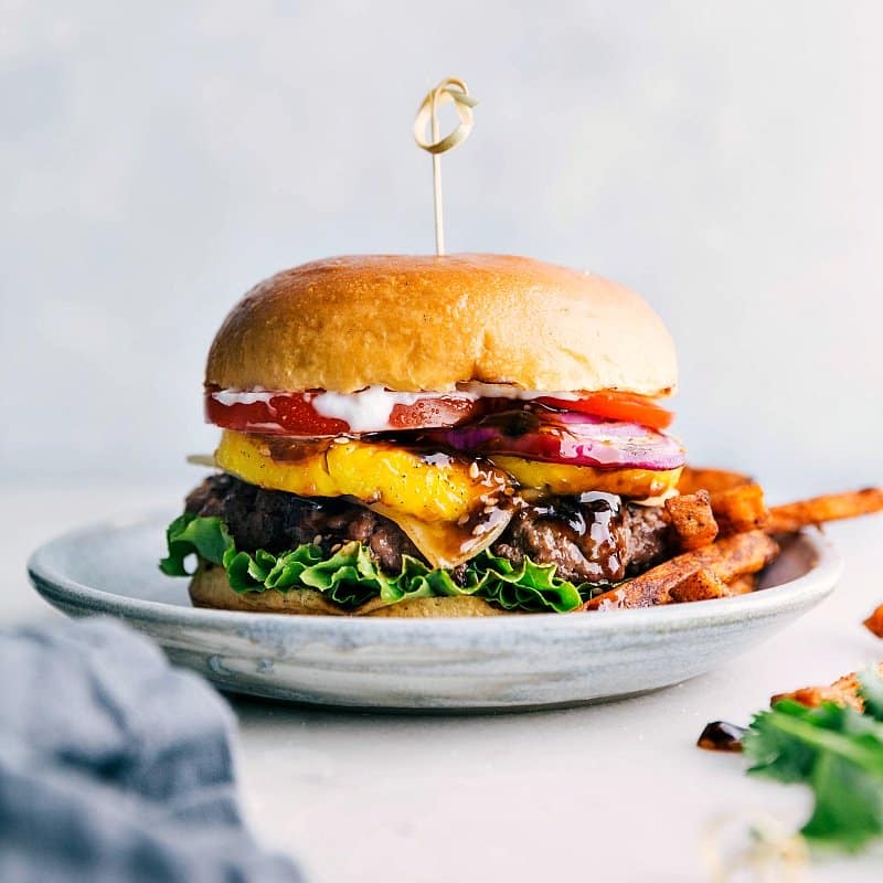 The finished teriyaki burger, juicy and bursting with flavor, ready for any occasion, served alongside a portion of fries.