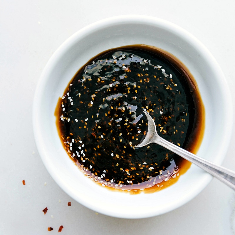 Homemade teriyaki sauce in a bowl, thick and flavorful, prepared for enhancing the meal.