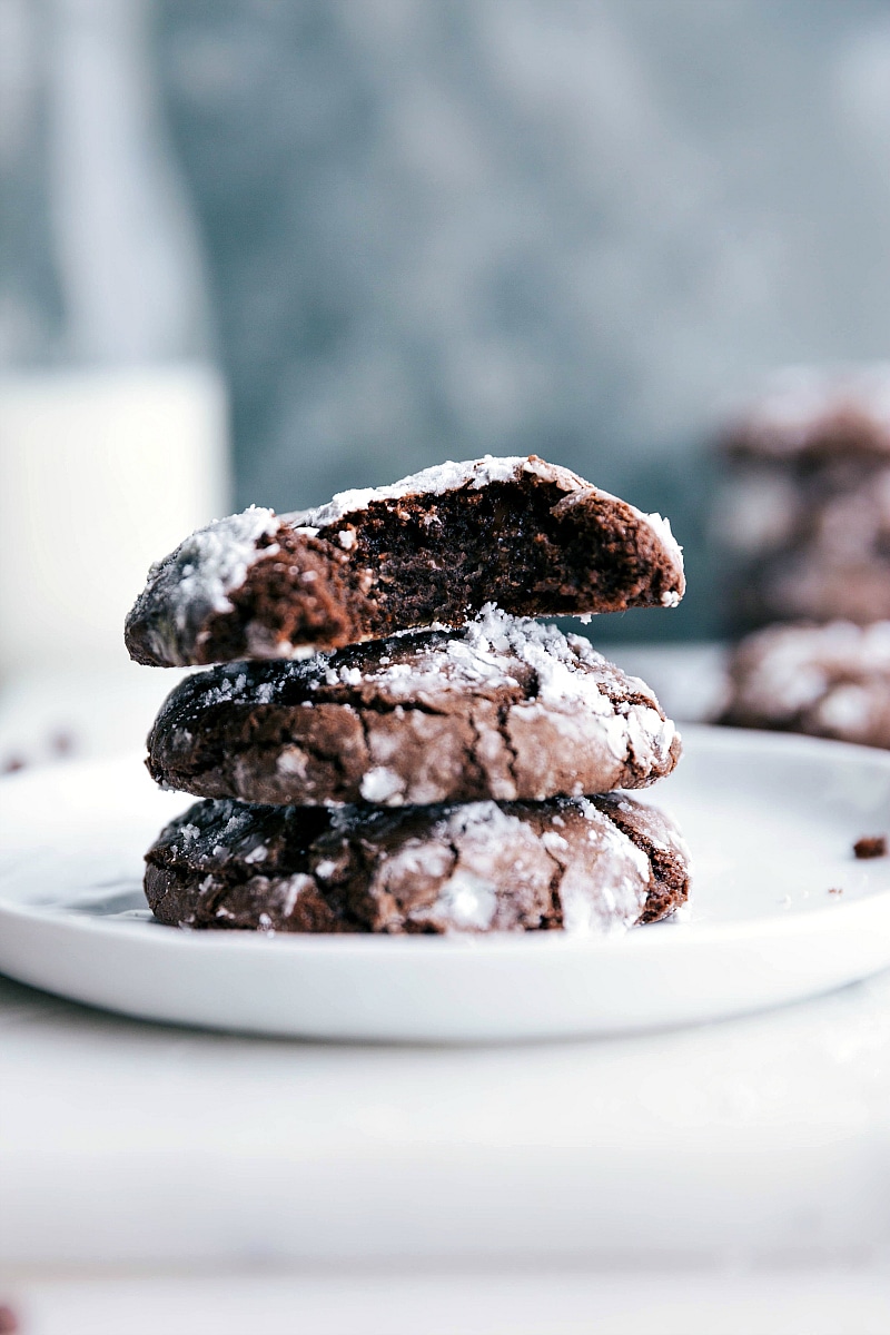 The finished chocolate crinkle cookie recipe, with cookies stacked and split to reveal their soft, gooey interiors.