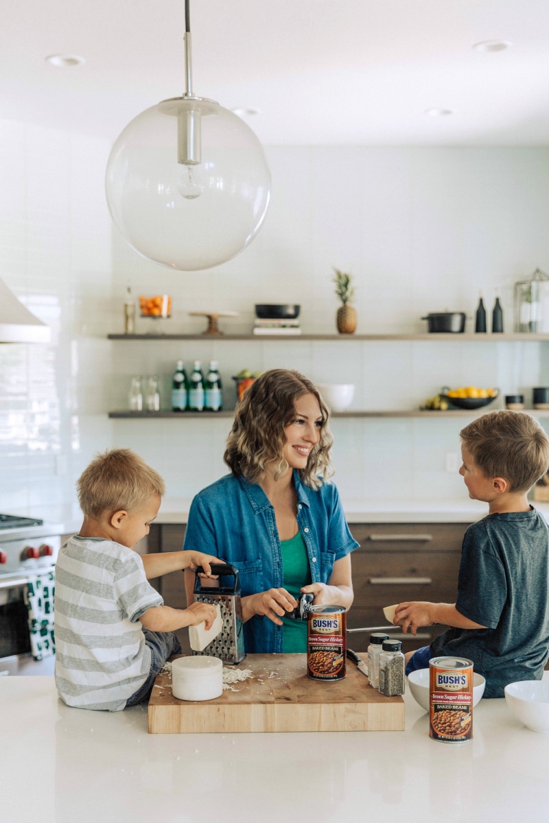 Chelsea and her boys in the kitchen, prepping the ingredients for the delicious recipe.