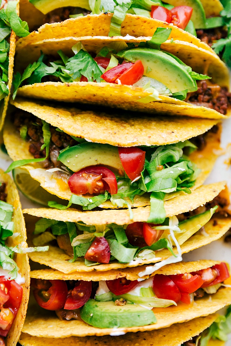 Overhead image of Beef Tacos with all the toppings on them, still in the casserole dish.