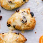 Delightful tart cherry scones with a drizzling of sweet glaze on top, a scrumptious dessert ready to be savored.