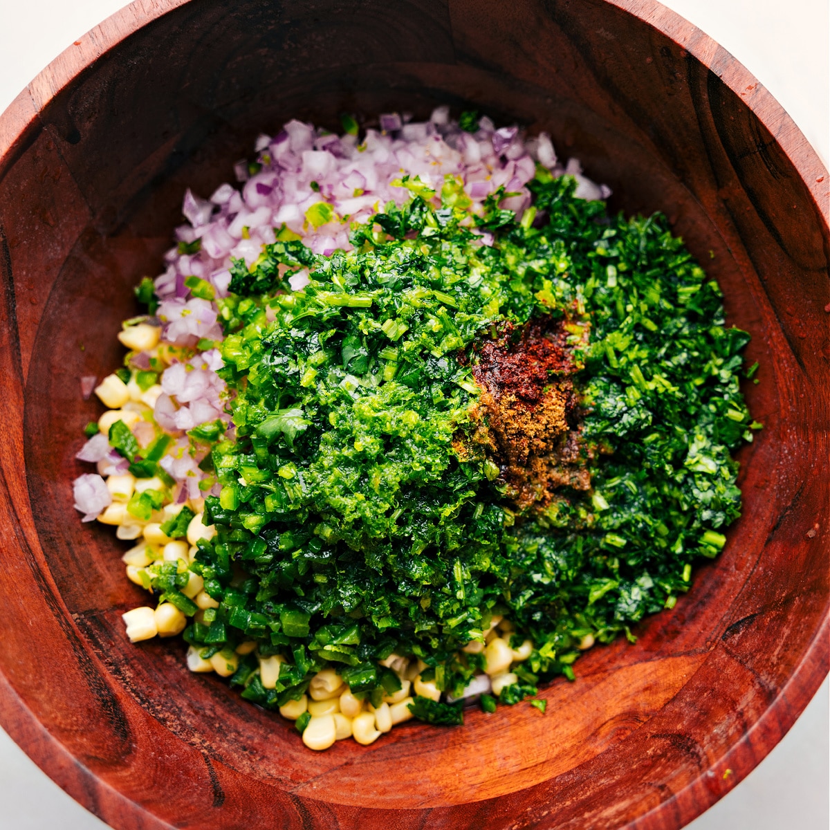 All the corn salsa recipe ingredients piled together in a bowl
