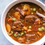Instant pot beef stew in a bowl, warm and hearty, ready to be eaten.