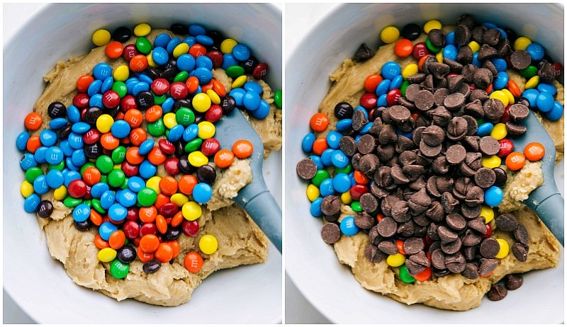 Candies and chocolate chips being added to the cookie dough, adding bursts of color and chocolatey goodness.