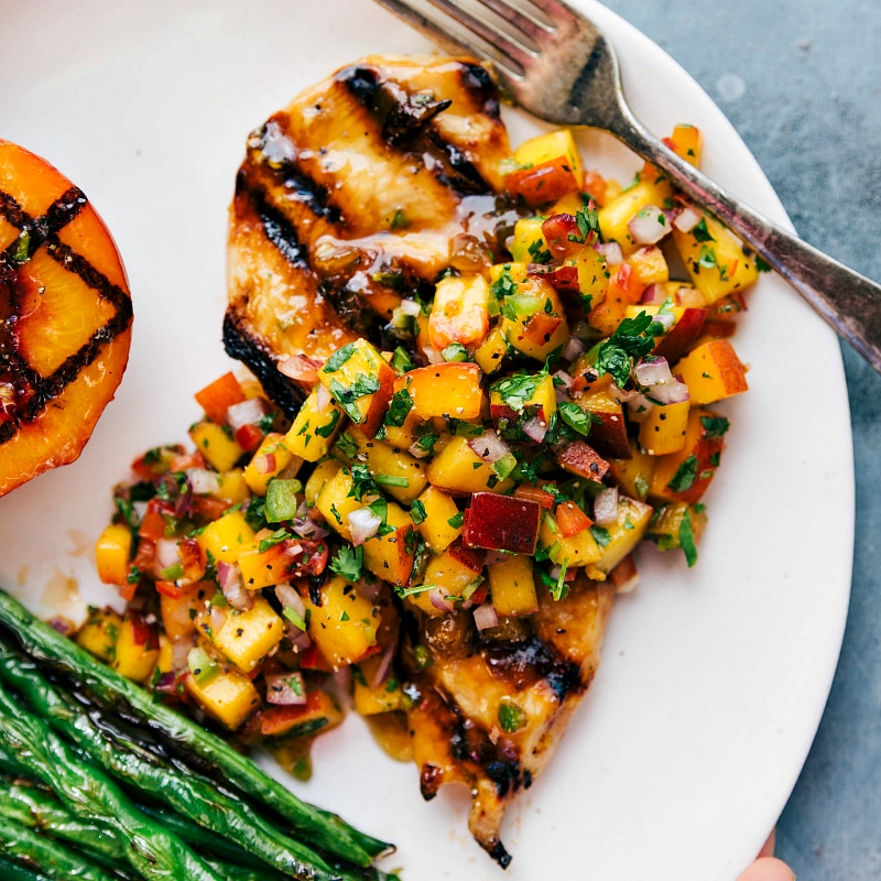 Overhead image of Peach Salsa Chicken with salsa on top and green beans on the side.