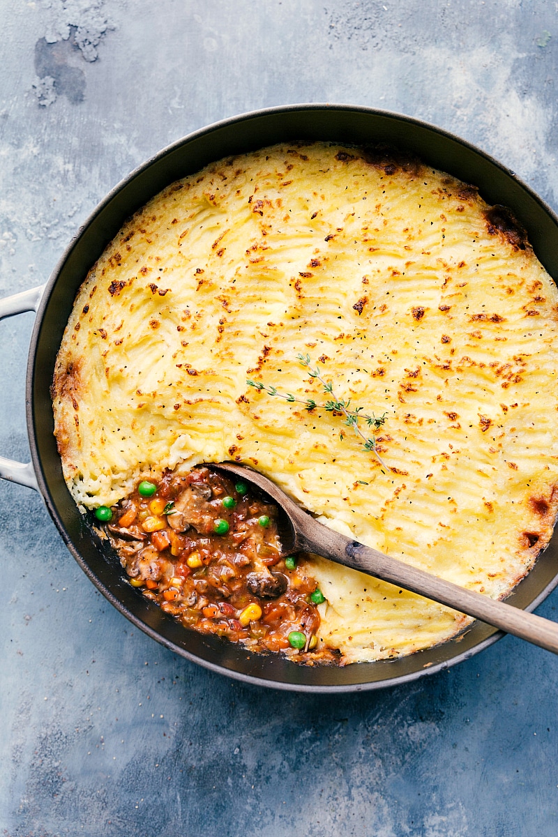 Overhead image of the vegetarian Shepards pie still in the pot with a wooden spoon in it