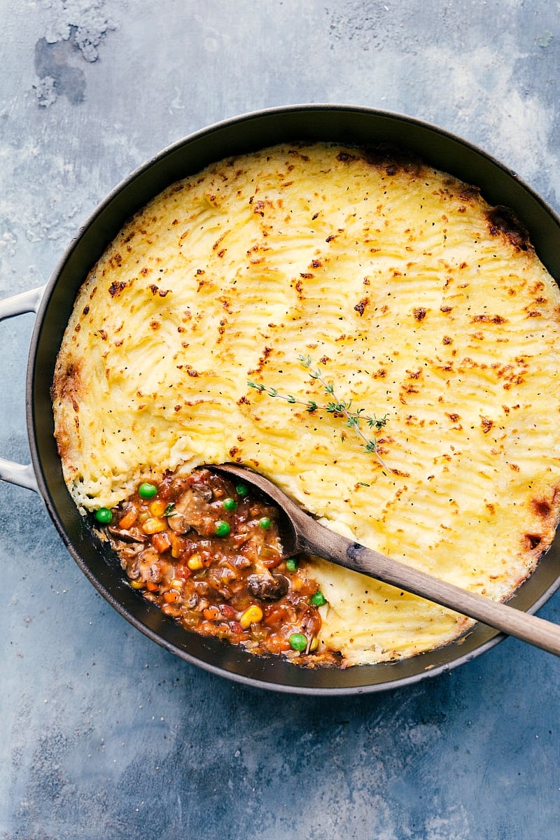 Shepherd's pie vegetarian variation still in the pot with a wooden spoon in it.