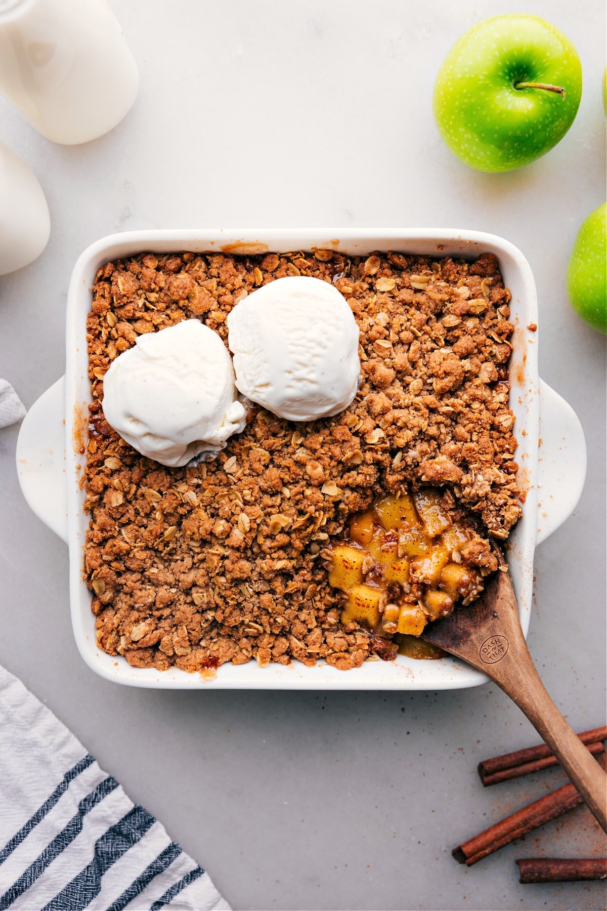 Overhead view of a golden-brown apple crumble in a dish.