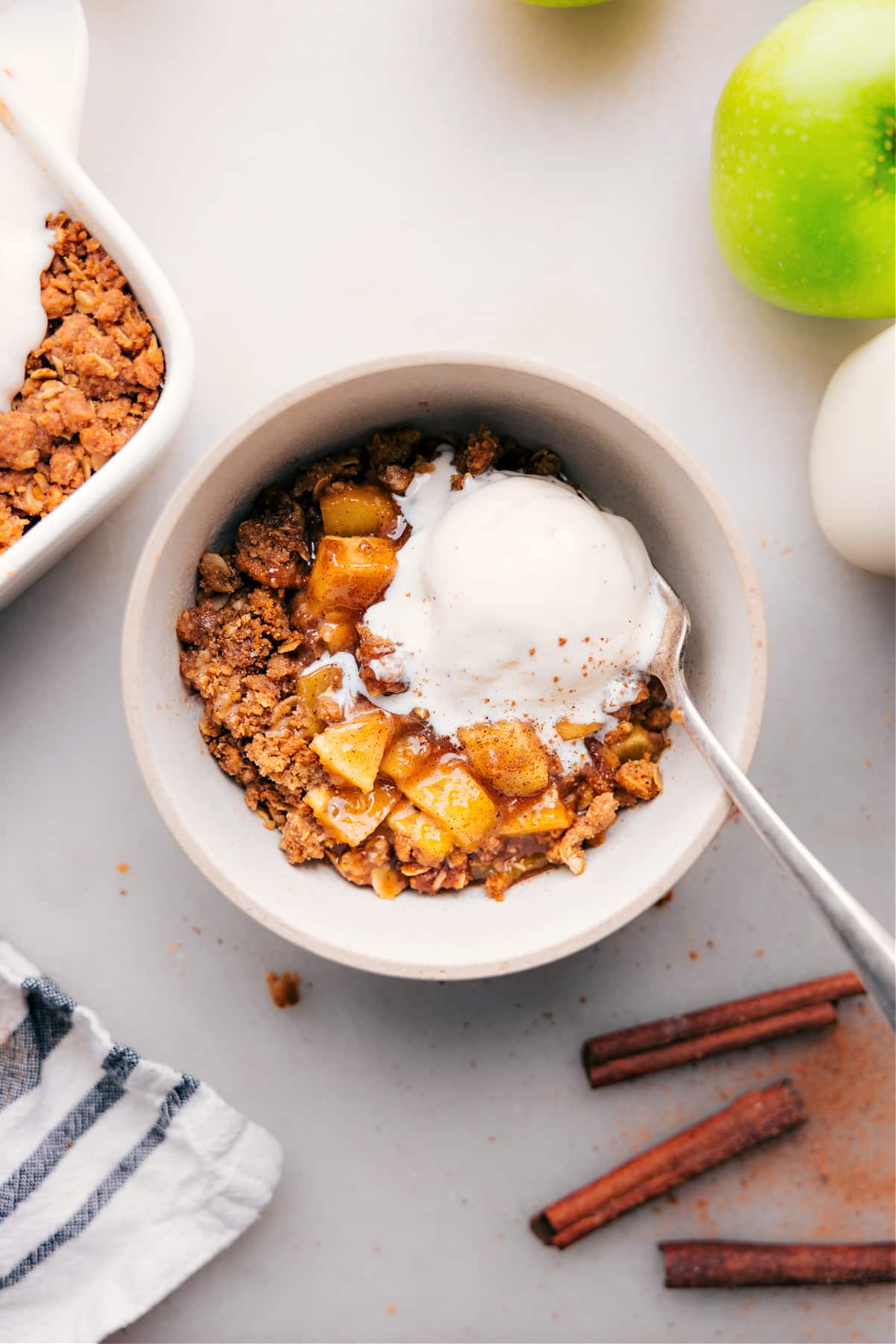 Delicious bowl of the warm dessert with a generous scoop of creamy vanilla ice cream on top.