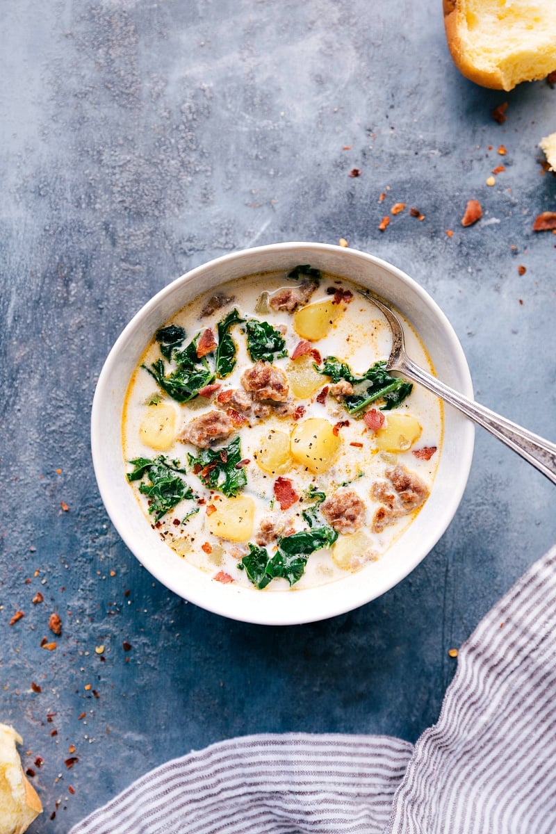 Finished zuppa toscana soup topped with fresh herbs, a creamy and delicious meal.