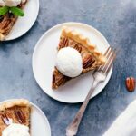 Slices of pecan pie with ice cream, mint, a tempting dessert delight.
