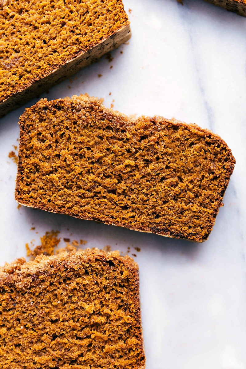 Overhead image of three slices of pumpkin bread fresh out of the oven