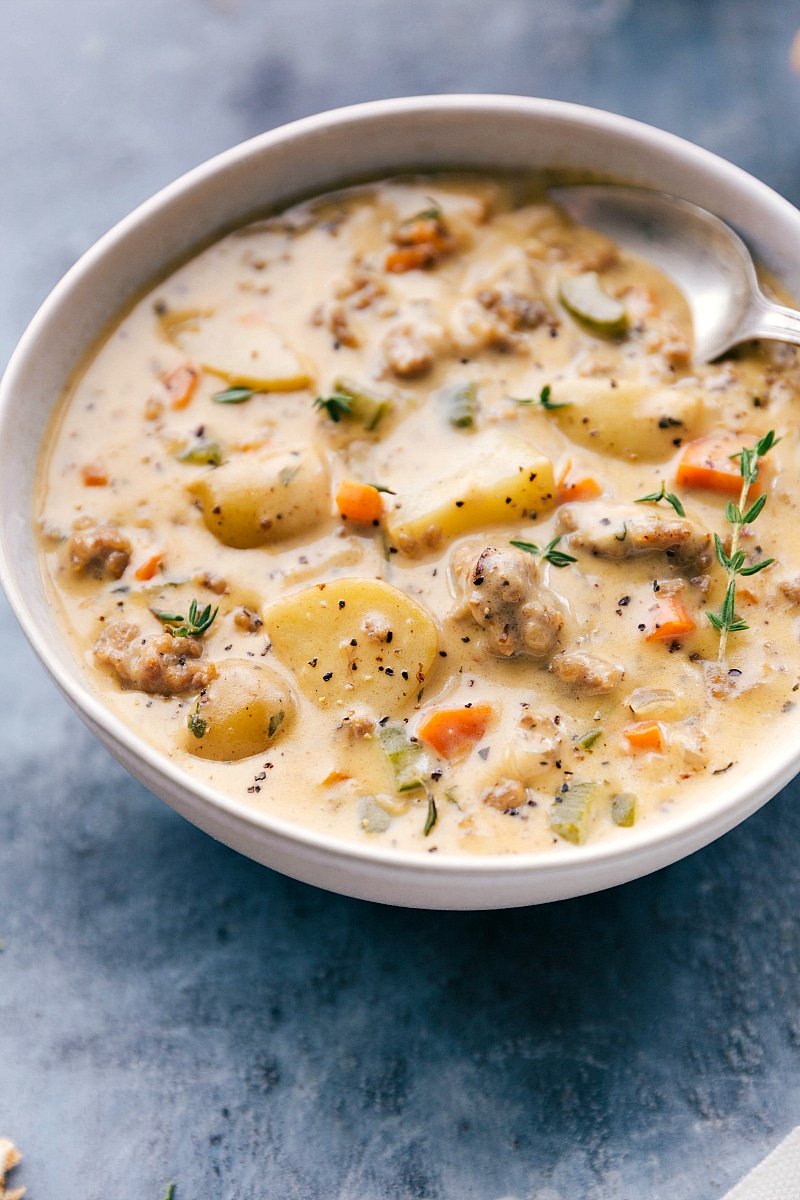 Finished sausage and potato soup full of vegetables and spices, warm and ready to be enjoyed.