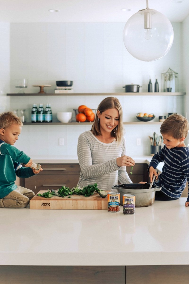 Chelsea and her boys making the black bean sweet potato chili together in the kitchen.