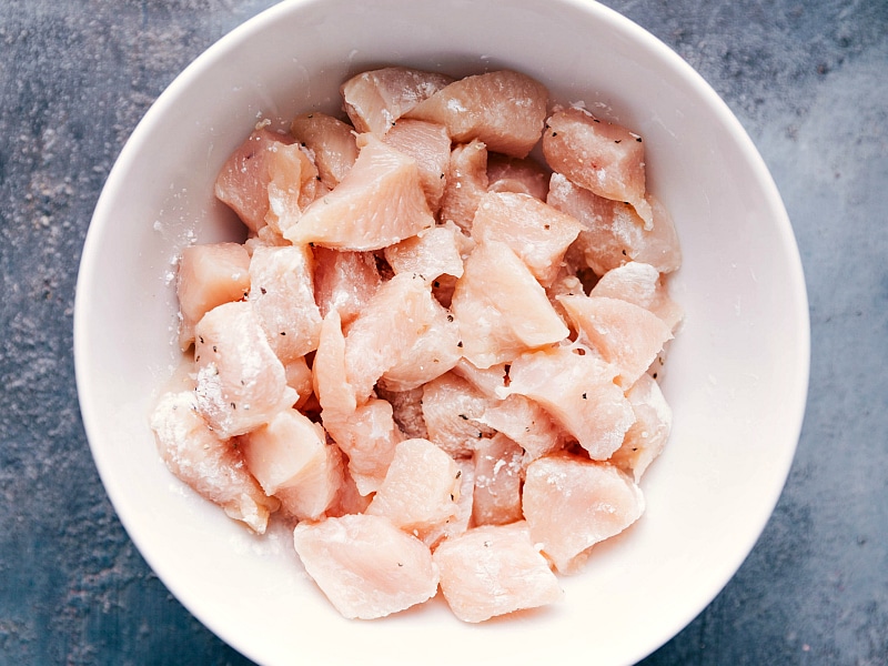 Process shot-- image of raw chicken being prepped for Black Pepper Chicken.