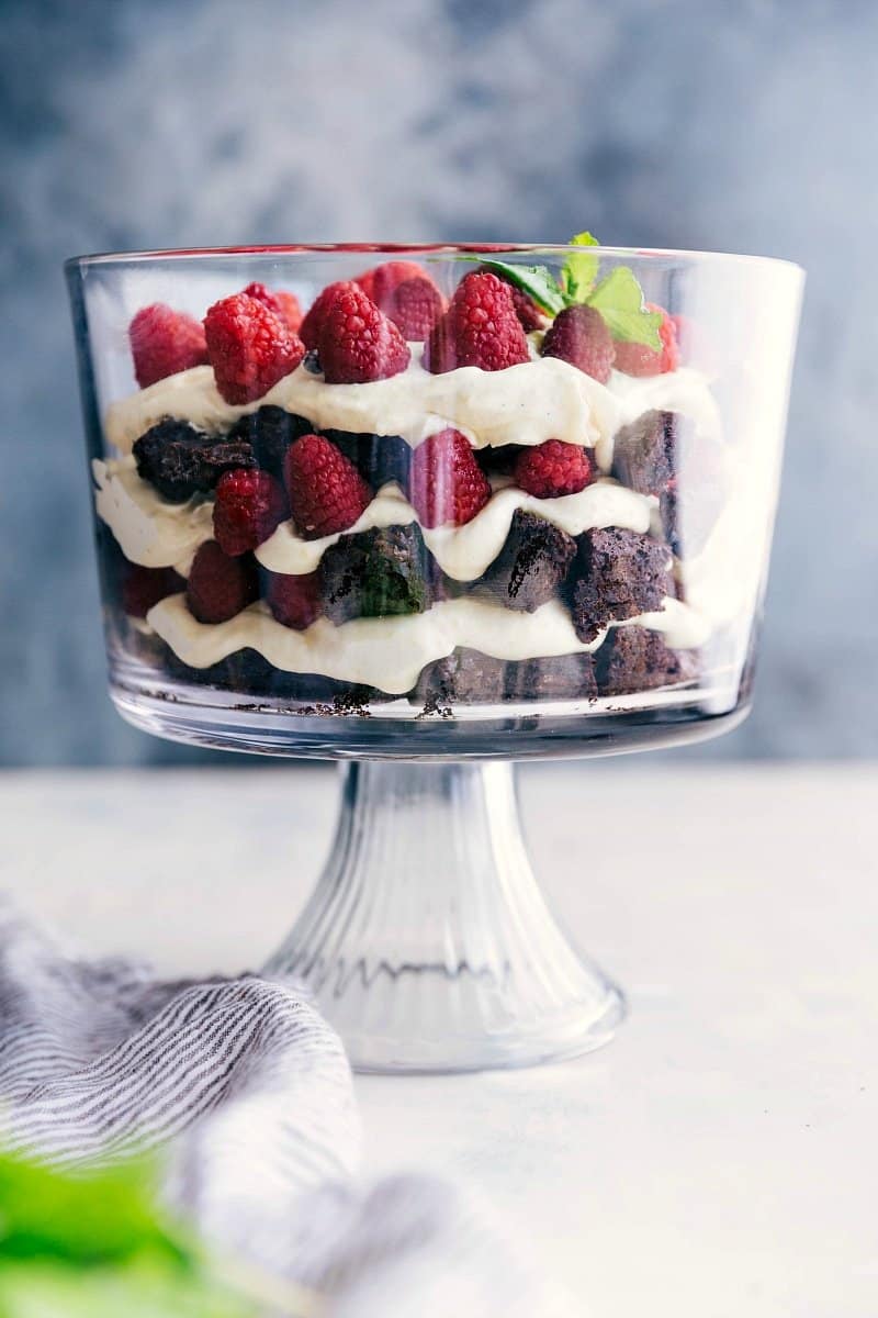 A stunning brownie trifle displaying layers of brownies, fresh fruit, and luscious cream filling, all set and inviting.