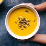 A bowl of warm and flavorful butternut squash soup, perfect for enjoying on a cold evening.