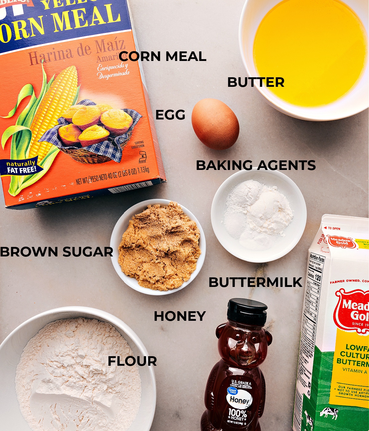 Ingredients used in cornbread recipe including butter, buttermilk, egg, honey, sugars, flour, cornmeal, baking agents, and cornstarch.