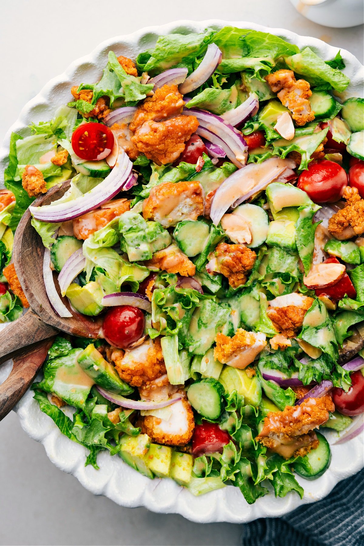 Ready-to-Eat Crispy Chicken Salad, Delicious and Satisfying Crispy Chicken Salad drizzled with delicious dressing in a bowl.