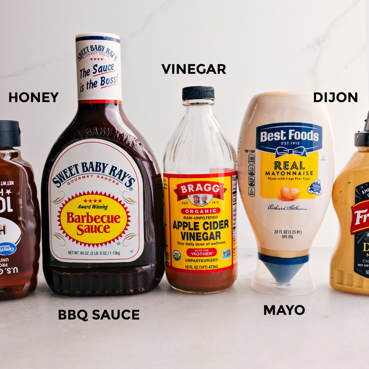 For this crispy chicken salad, the dressing ingredients are prepped for easy assembly: honey, BBQ sauce, vinegar, Dijon, and mayo.