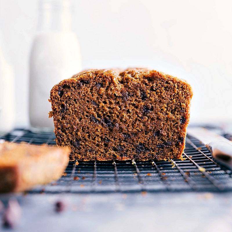 Image of the best Pumpkin Chocolate Chip Bread with a slice out of it.