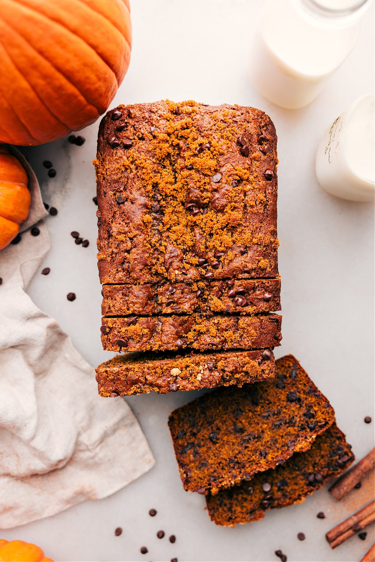 Pumpkin chocolate chip bread with slices cut out, revealing the delicious and fluffy interior.