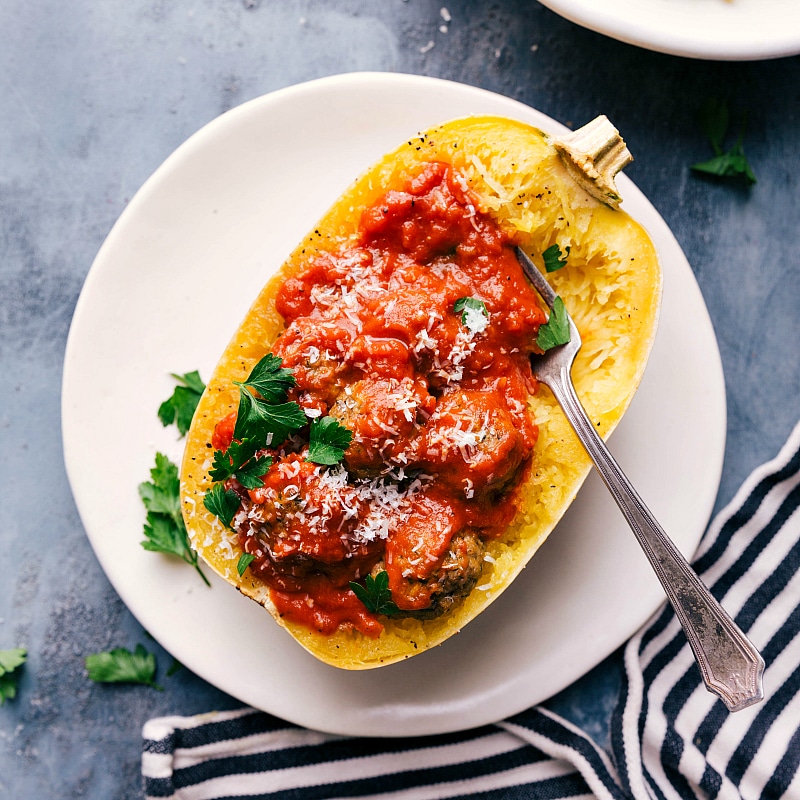 Overhead image of Spaghetti Squash with Turkey Meatballs still in the squash with marinara sauce over it.