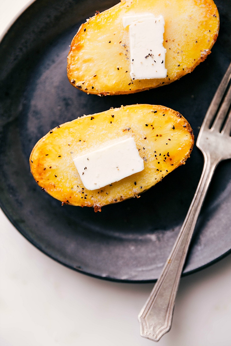 Overhead image of Baked Potatoes on a plate, ready to be eaten.