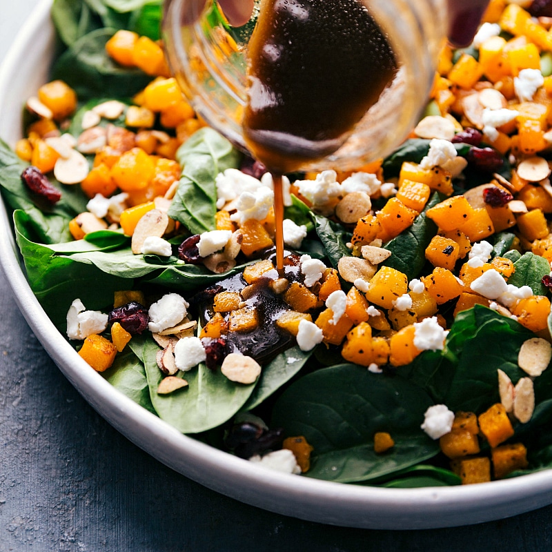 Overhead image of the dressing being poured over Thanksgiving Salad.