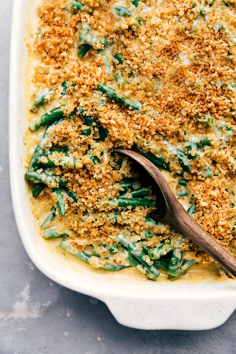 Image of the ready-to-eat Green Bean Casserole with a spoon in the pan.