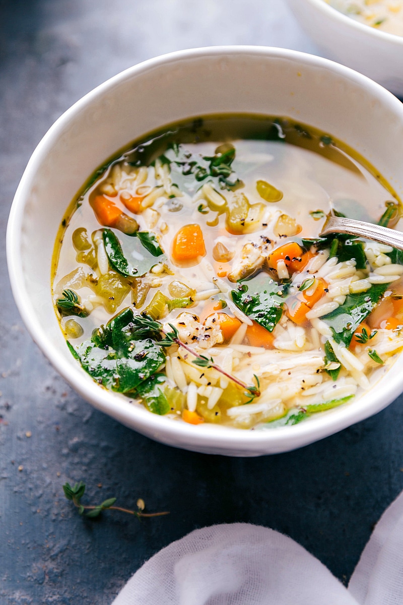 Up-close image of the soup with a spoon in it, ready to be eaten.