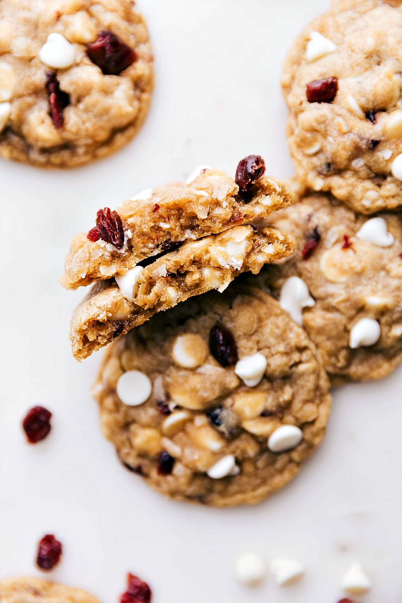 Warm, freshly baked dessert split open, revealing a gooey interior with melted white chocolate chips.