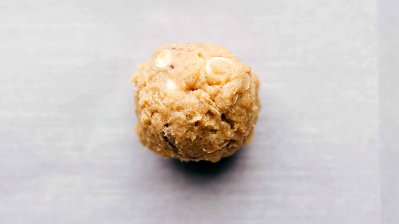 Process shot-- image of the Oatmeal Cranberry Cookies being rolled into balls, ready for baking.