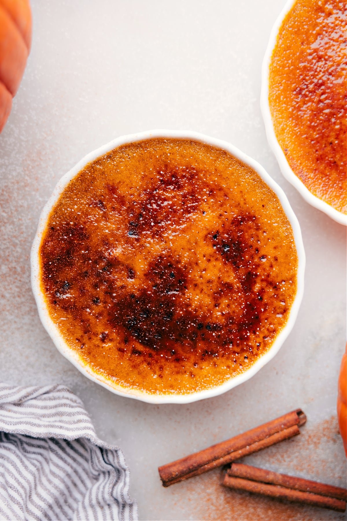 Golden caramelized sugar crust atop creamy Pumpkin Créme Brûleé in a ramekin.