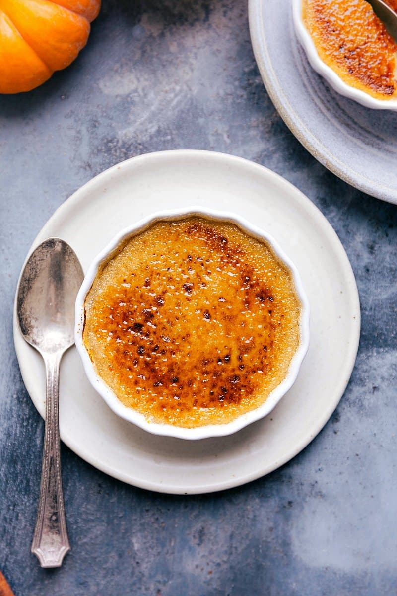 Overhead image of a Pumpkin Creme brûlée with a spoon on the side, ready to be eaten.