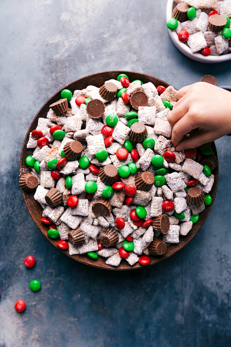 Overhead image of Reindeer Chow with a hand reaching in to take some.