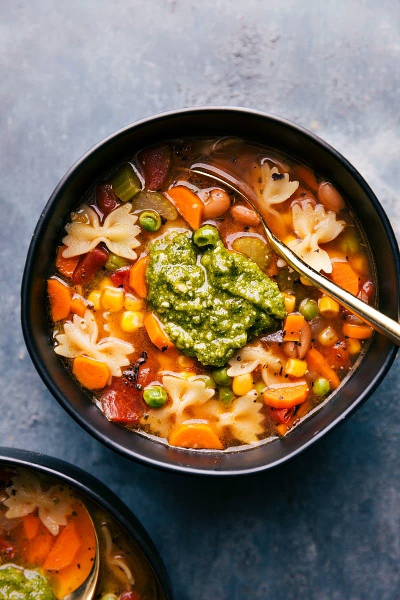 Overhead image of the vegetable soup with pesto on top.