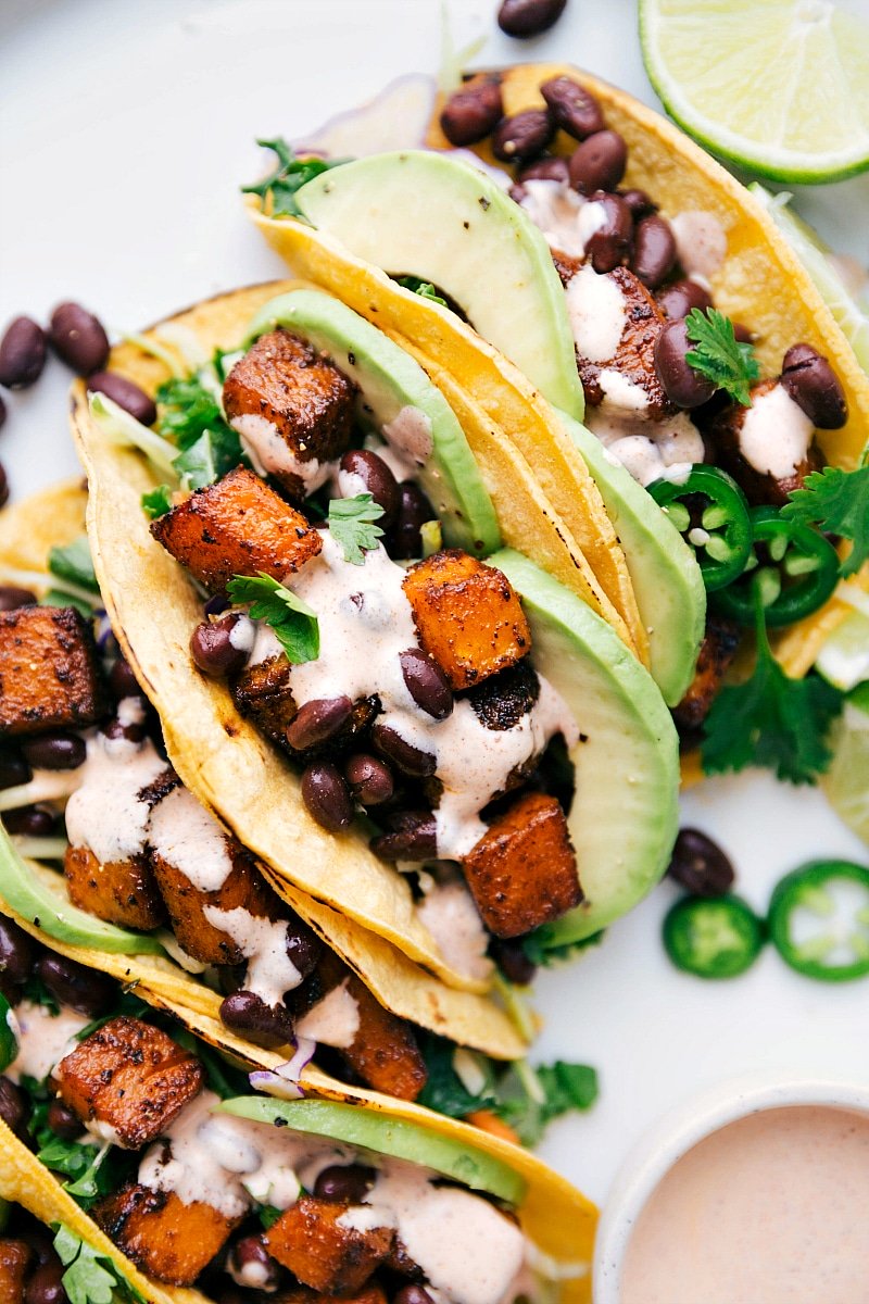 Overhead image of Butternut Squash Tacos with dressing and toppings, ready to be served