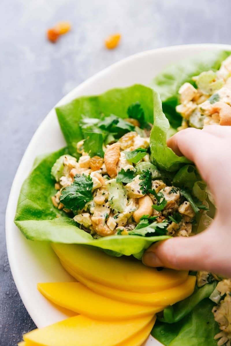 A vibrant and appetizing curry chicken salad nestled in a crisp lettuce wrap, bursting with colors and flavors, ready for a healthy bite.