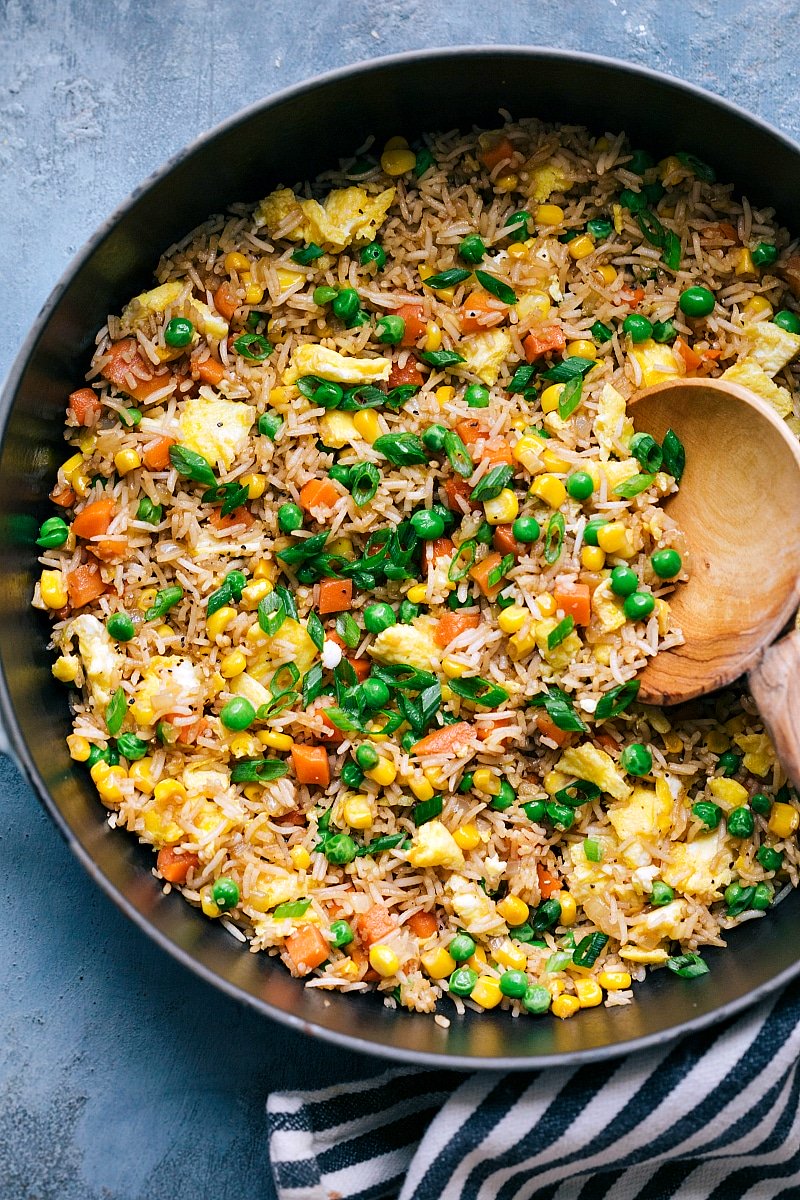 Plate of flavorful fried rice with a mix of vegetables, egg, and seasonings.