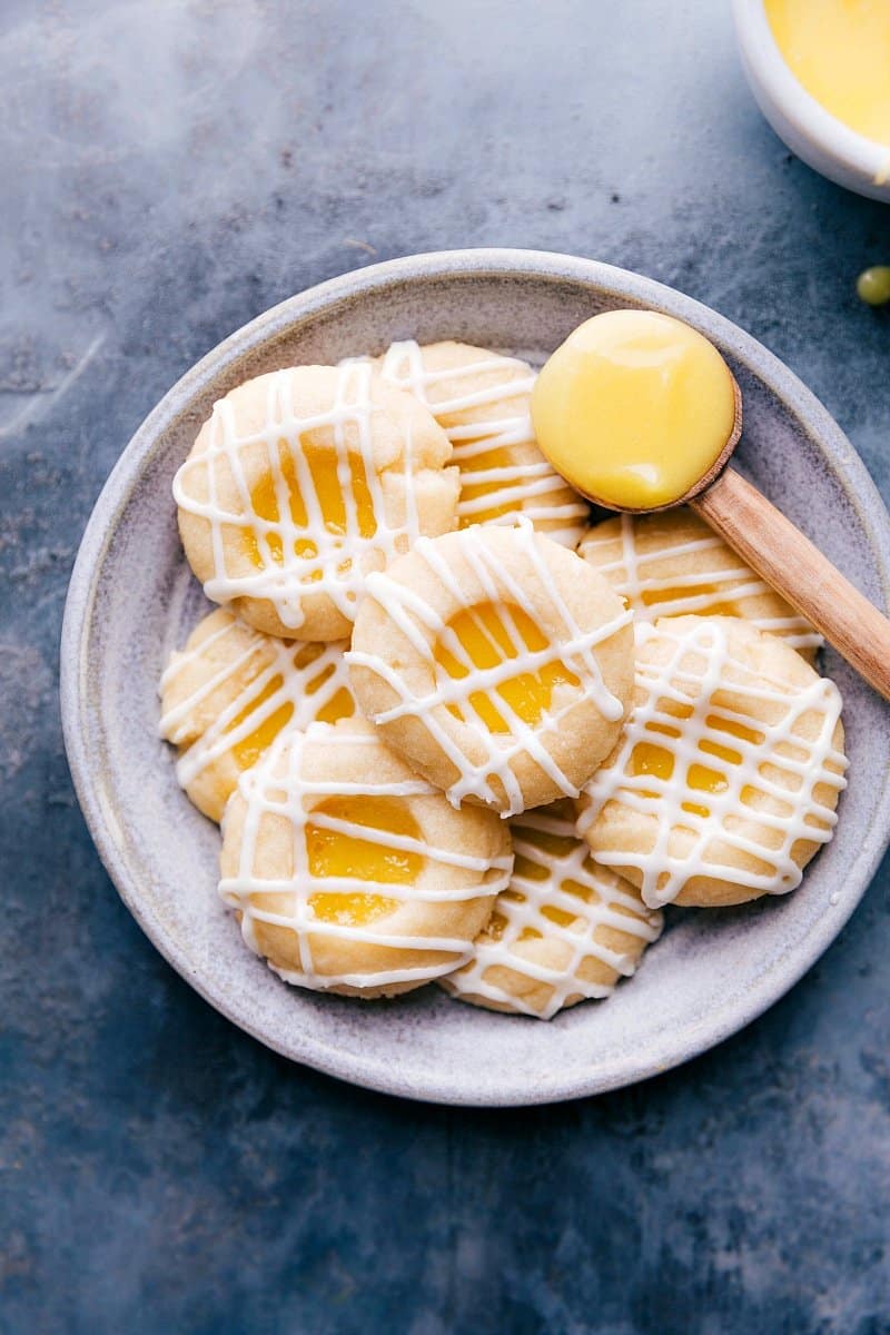 Overhead photo of finished Lemon Curd Cookies with a spoonful of lemon curd alongside.