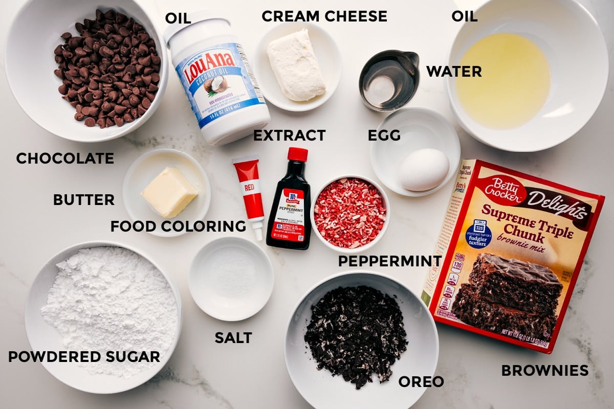 Ingredients In Peppermint Brownies All the ingredients in this recipe prepped out for easy assembly including chocolate, butter, food coloring, salt, powdered sugar, Oreo, cream cheese, peppermint, extract, egg, oil, water, and brownie mix.