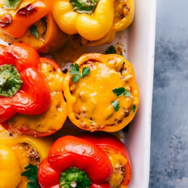 Freshly baked stuffed peppers with a cheesy, savory filling on display, ready to serve.