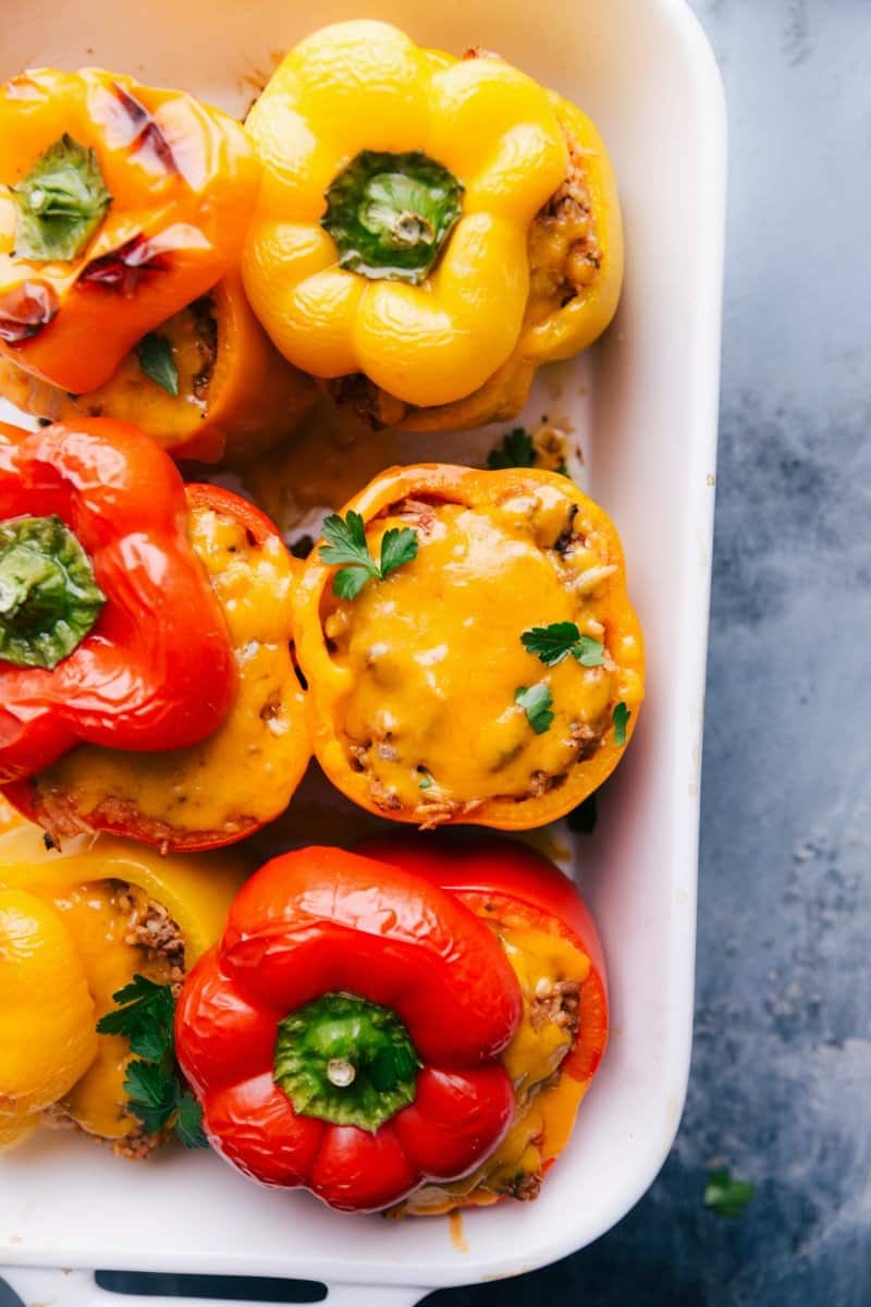 Freshly baked stuffed peppers with a cheesy, savory filling on display, ready to serve.