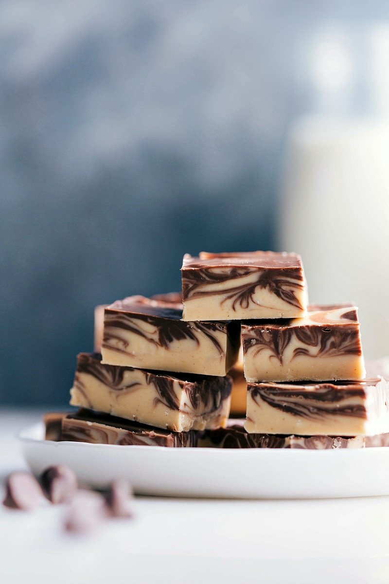 Stacked slices of tiger butter fudge with distinctive chocolate and peanut butter swirls.