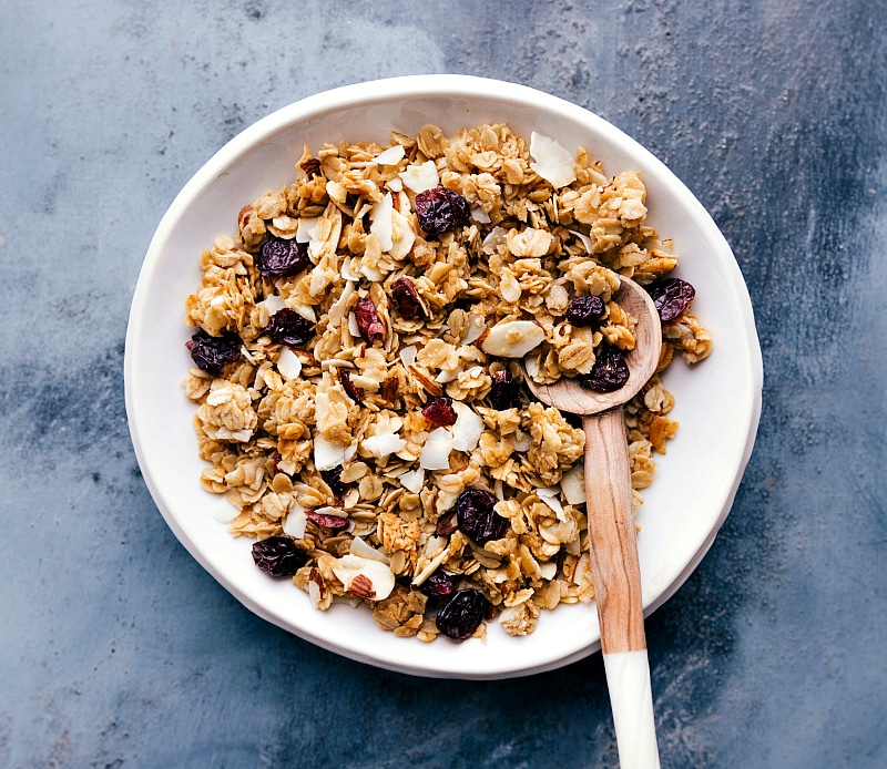 Image of Almond Granola in a bowl with a spoon in it.