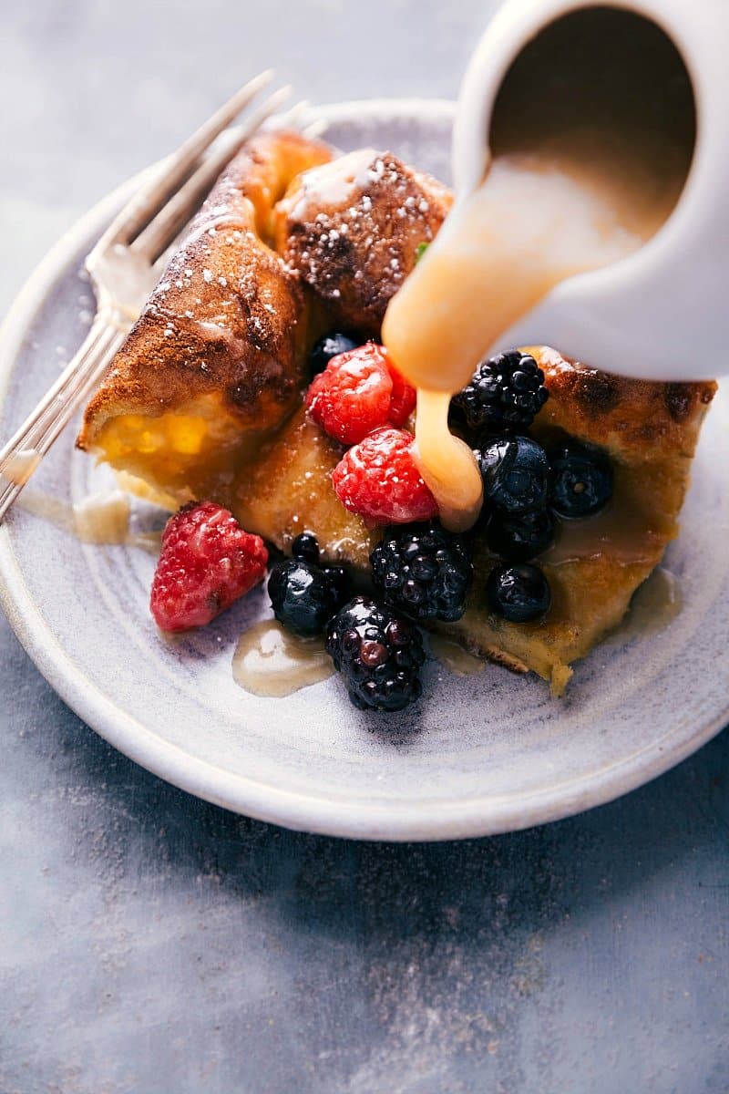 Buttermilk syrup cascading over a freshly baked dutch baby, creating a delectable contrast.